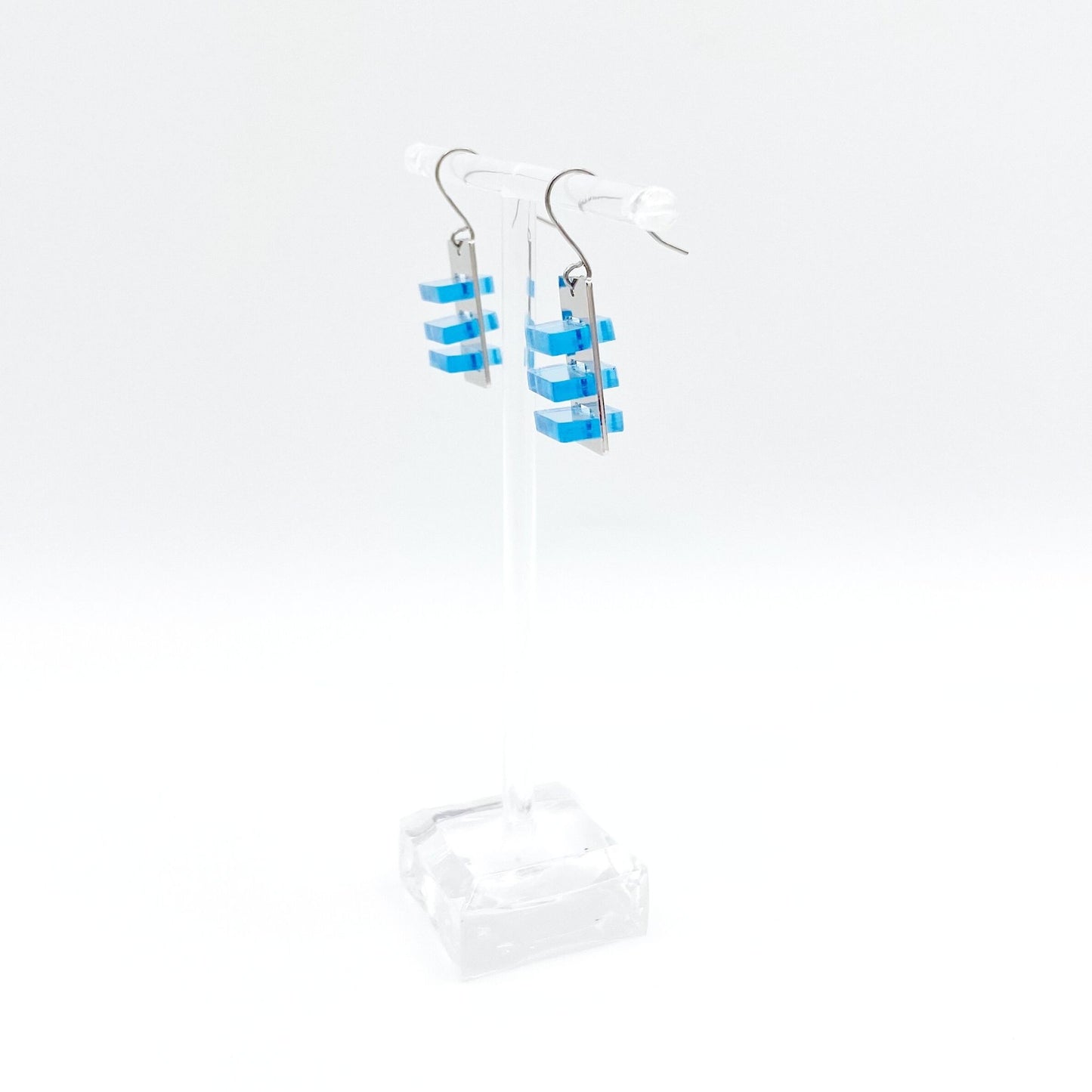 space between silver and blue earring david howell